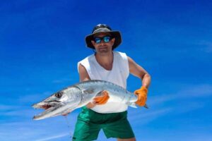 Man wearing holding barracuda caught in the Florida Keys
